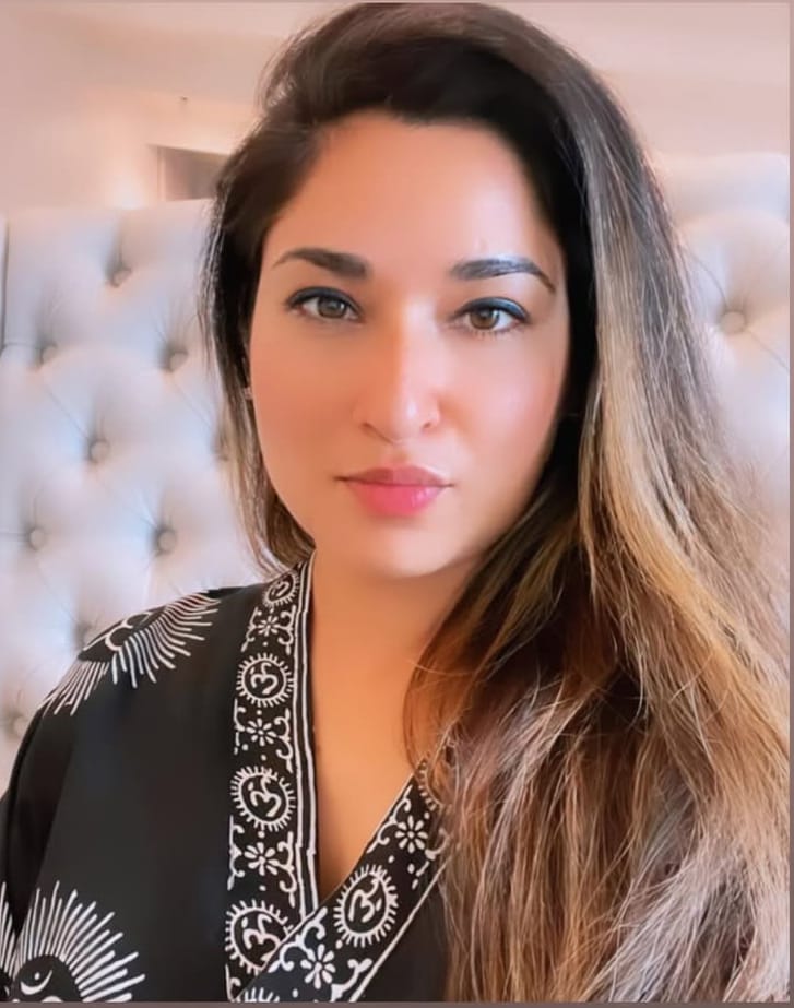 Dr. Shaveta Jasra, an Ayurvedic doctor wearing professional attire, smiling warmly at the camera